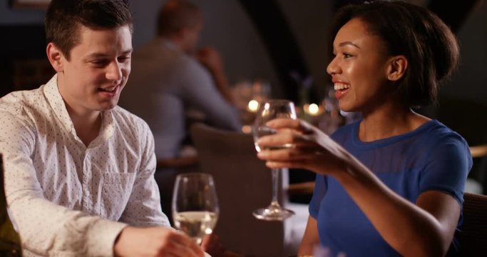 4K Cute couple on a date in restaurant, drinking wine & getting to know each other