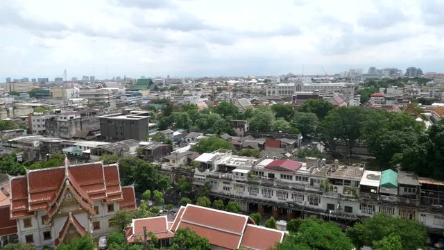 panning shot of bangkok city looking east from phu khao thong, golden mount, at wat saket temple