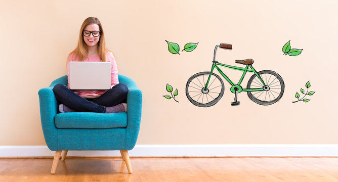 Eco Bicycle with young woman using her laptop in a chair