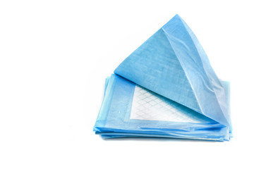 pile of absorbing pads for pets isolated on white. home training carpets for animals