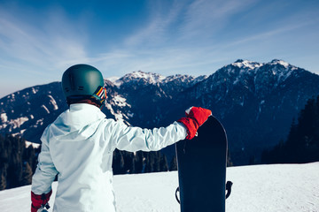 Fototapeta na wymiar one snowboarder with snowboard on winter mountain top