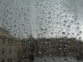 Amazing waterdrop effect on the window after rain with a beautiful riflection and some small bubble