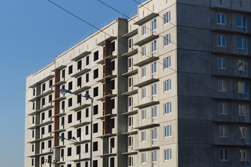 Construction of a multi-storey building on blue sky background