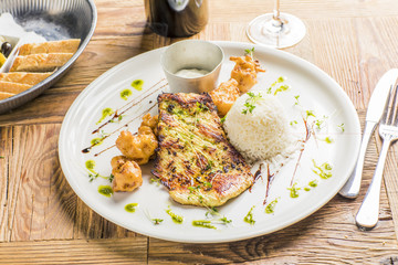 grilled roasted bbq chicken on wooden table with fried broccoli dip and wine