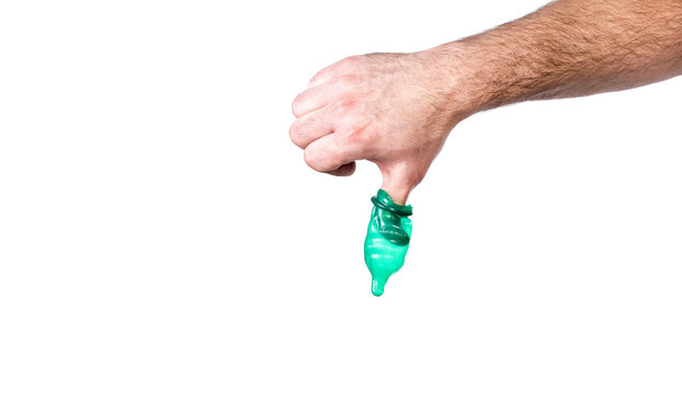 safe sex concept , holding condom in hand
