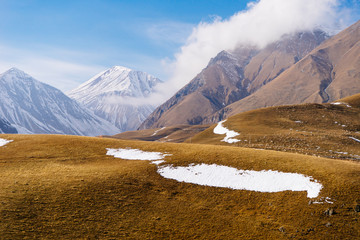 inspiring nature, majestic mountains covered with white snow and fields
