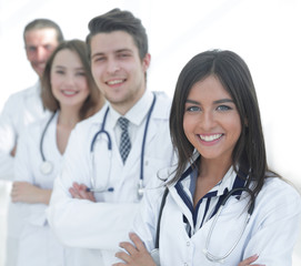 Fototapeta premium female doctor with group of happy successful colleagues