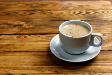 cup of coffee on a wooden background