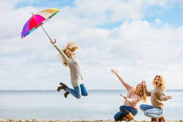 Women jumping with umbrella © anetlanda