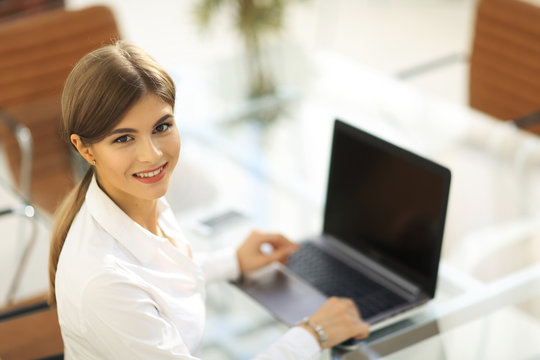 portrait of young woman working with a laptop .