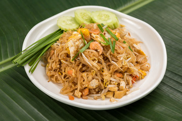 Fried Rice Sticks with Shrimp in white dish on banana leaf