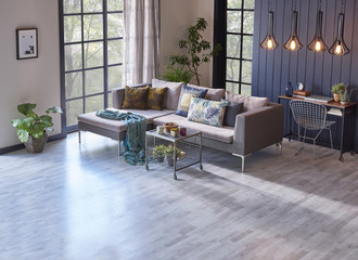 living room blue and cream wall decorative windows and grey armchair with middle stand