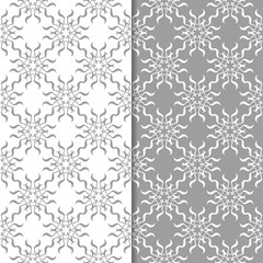 White and gray floral ornaments. Set of seamless backgrounds