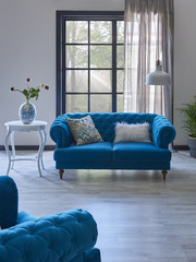 decorative living room home interior with blue furniture and white coffee table.