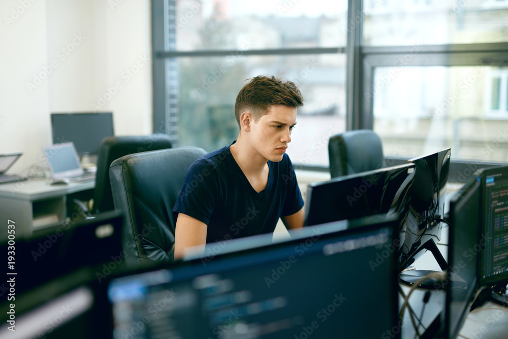 Wall mural programming. man working on computer in it office