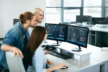 IT Team Working In Office. People Programming On Computer