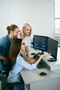 IT Team Working In Office. People Programming On Computer
