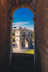 Obraz premium Arch of Constantine landmark and the symbol of Rome as seen from inside the Roman Colosseum