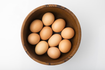 Food: Top View of Brown Eggs in Wooden Bowl Isolated on White Background Shot in Studio 