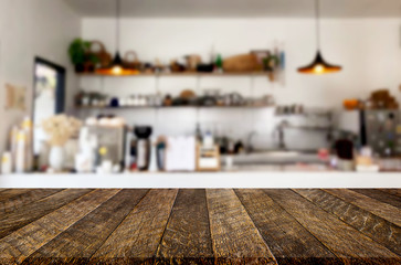Selected focus empty brown wooden table and Coffee shop or restaurant blur background with bokeh image. for your photomontage or product display.