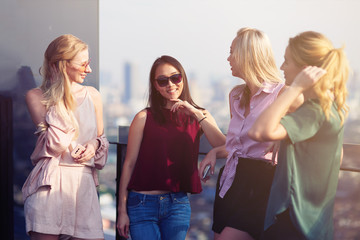 Cheerful girls resting on the roof top