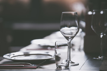 Plates and empty glasses served on a table in a restaurant