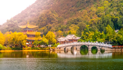 Suocui Bridge over Black Dragon Pool at Moon Embracing Pavilion in Jade Spring Park, Lijiang, China.