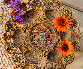 Pesah celebration concept (Jewish Passover holiday). Vintage traditional seder plate and matzoh.