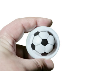 Fototapeta premium a man's hand holds a soccer ball toy in his hand. isolate white background