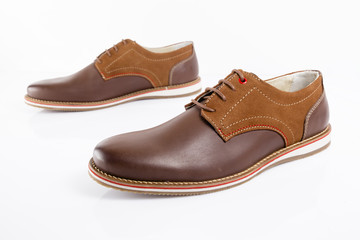 Male brown leather shoe on white background, isolated product, comfortable footwear.