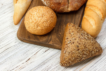assortment of baked bread on wood table. top view with copy space