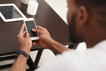 Closeup of male hands using smartphone with blank screen