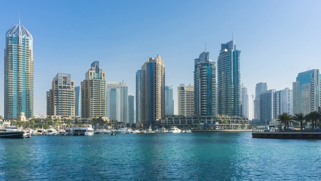 Panoramic view of Dubai Marina Towers and canal in Dubai time lapse