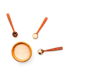 Aromatheraphy in spa. Chocolate brown spa salt on white background top view copy space