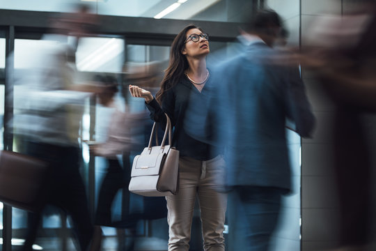 Woman Waiting During Rush Hour In Lobby