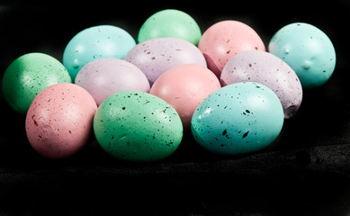 Horizontal, front view of a dozen, homemade,  colored, hard boiled eggs , celebrating Easter  