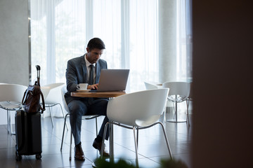 Businessman at airport waiting area