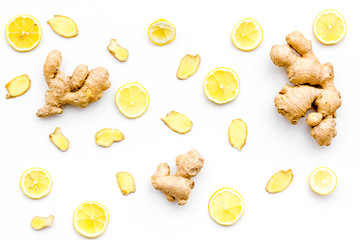 Fresh ginger root and lemon slices pattern on white background top view