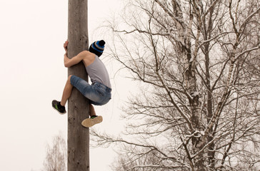 Festival. Boy climbs on a pole