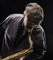 Naklejka premium Adult sax player with his instrument