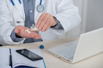 close up of hands of doctor with pills