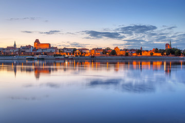 Torun old town over Vistula river at sunset, Poland