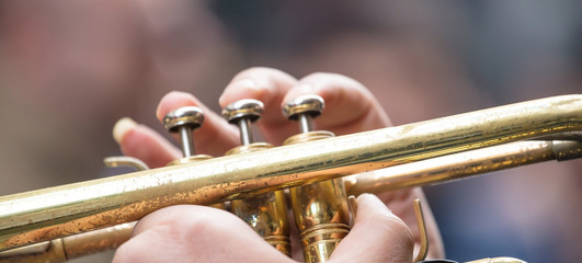 Musician with brass trumpet plays classical music. Close up view with details, blurred background, banner. © viperagp