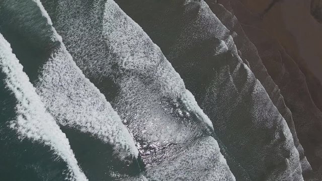 Top aerial view frop drone of Tropical exotic beach with volcanic sand in Bali, Indonesia