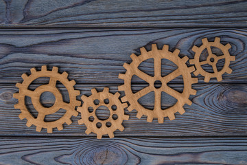 Gear wheels on a wooden background. The concept of creative, logical thinking. Logic background. gears of natural wood