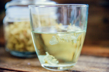 jasmine tea in a glass cup on the background of the old invoice board