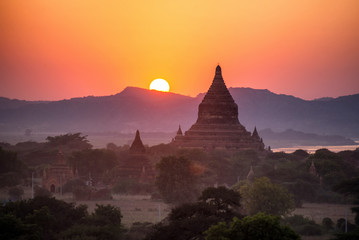 beautiful landscape view of sunrise and fog over ancient pagoda in Bagan , Myanmar