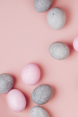 Group pale pink and gray Easter eggs on pastel  background. Flat lay