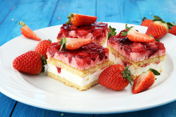 strawberry cake with fresh strawberries and whipped cream.