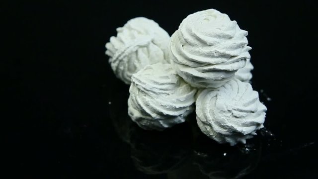 white zephyr lies on black background